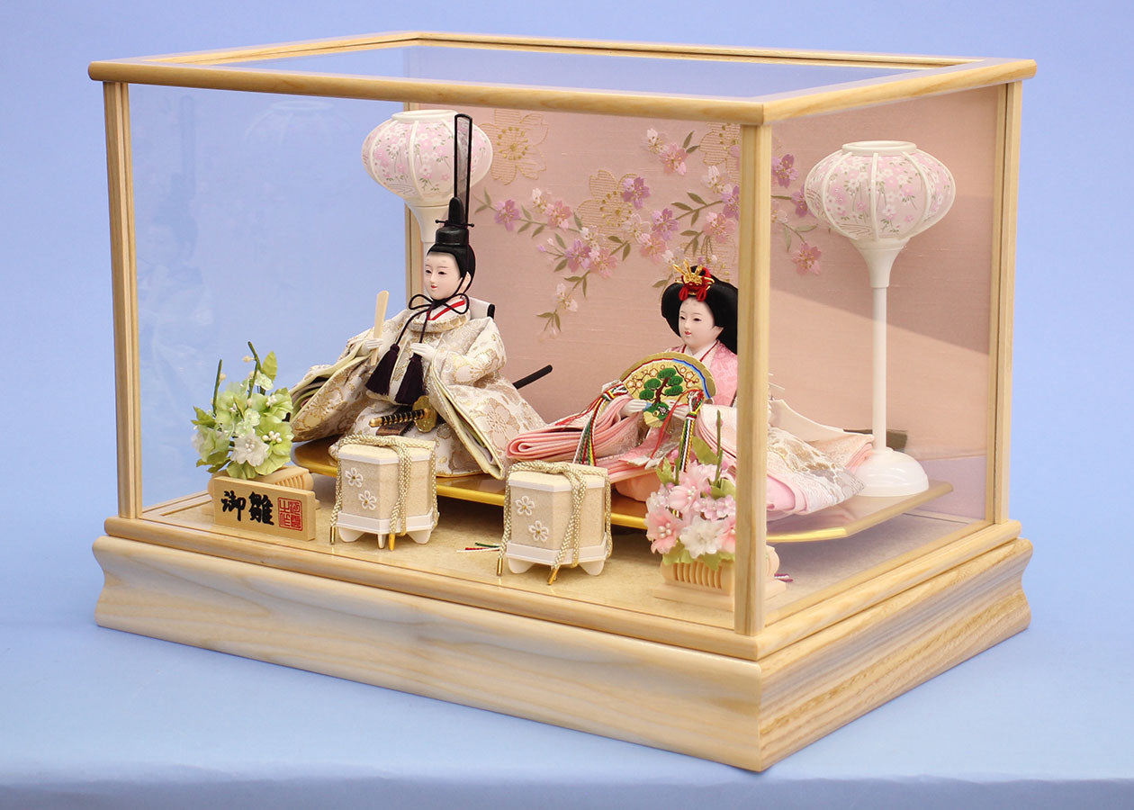 Hinadolls in a white wooden frame glass case